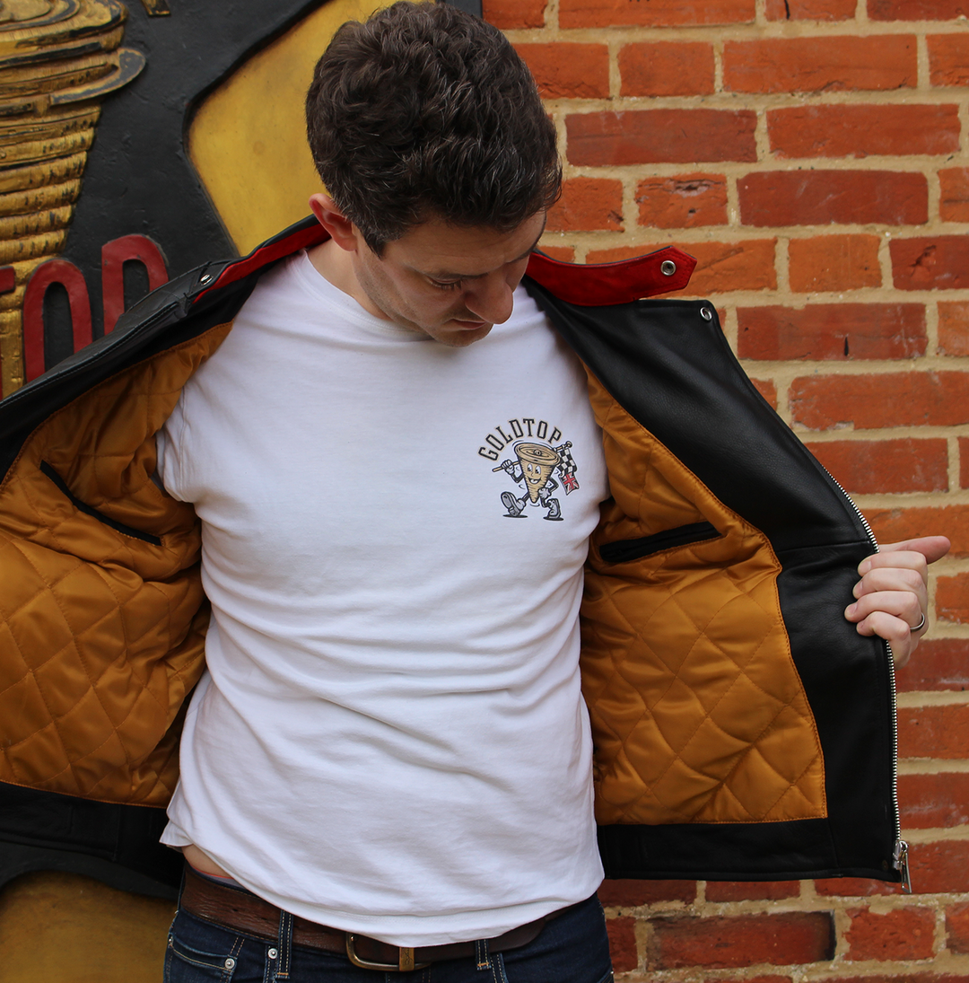 A man wearing a white Goldtop branded tshirt and new Bobber motorcycle jacket with premium matte gold lining.